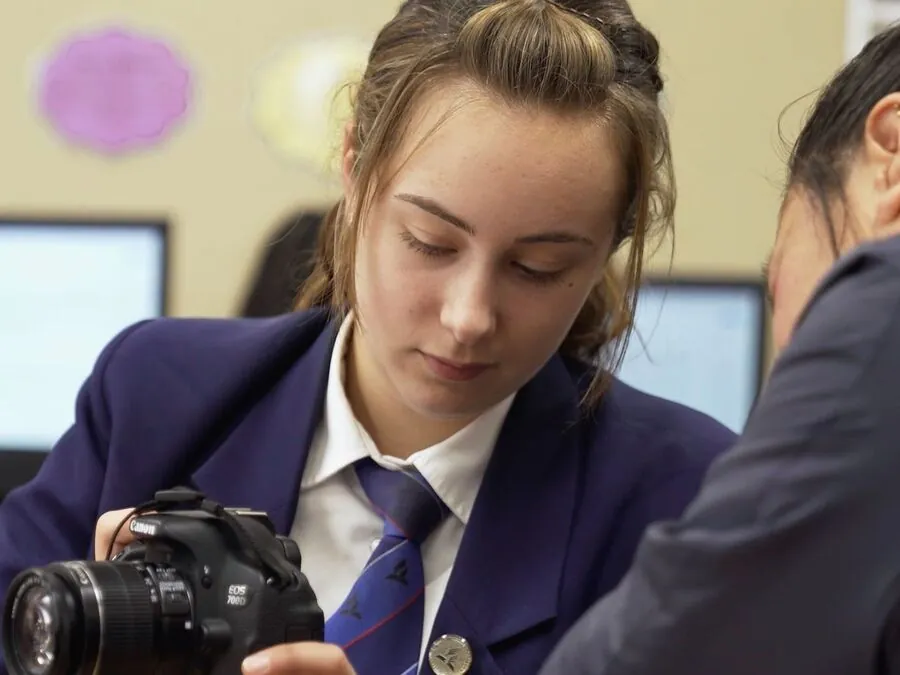 Student learning photography in a media class